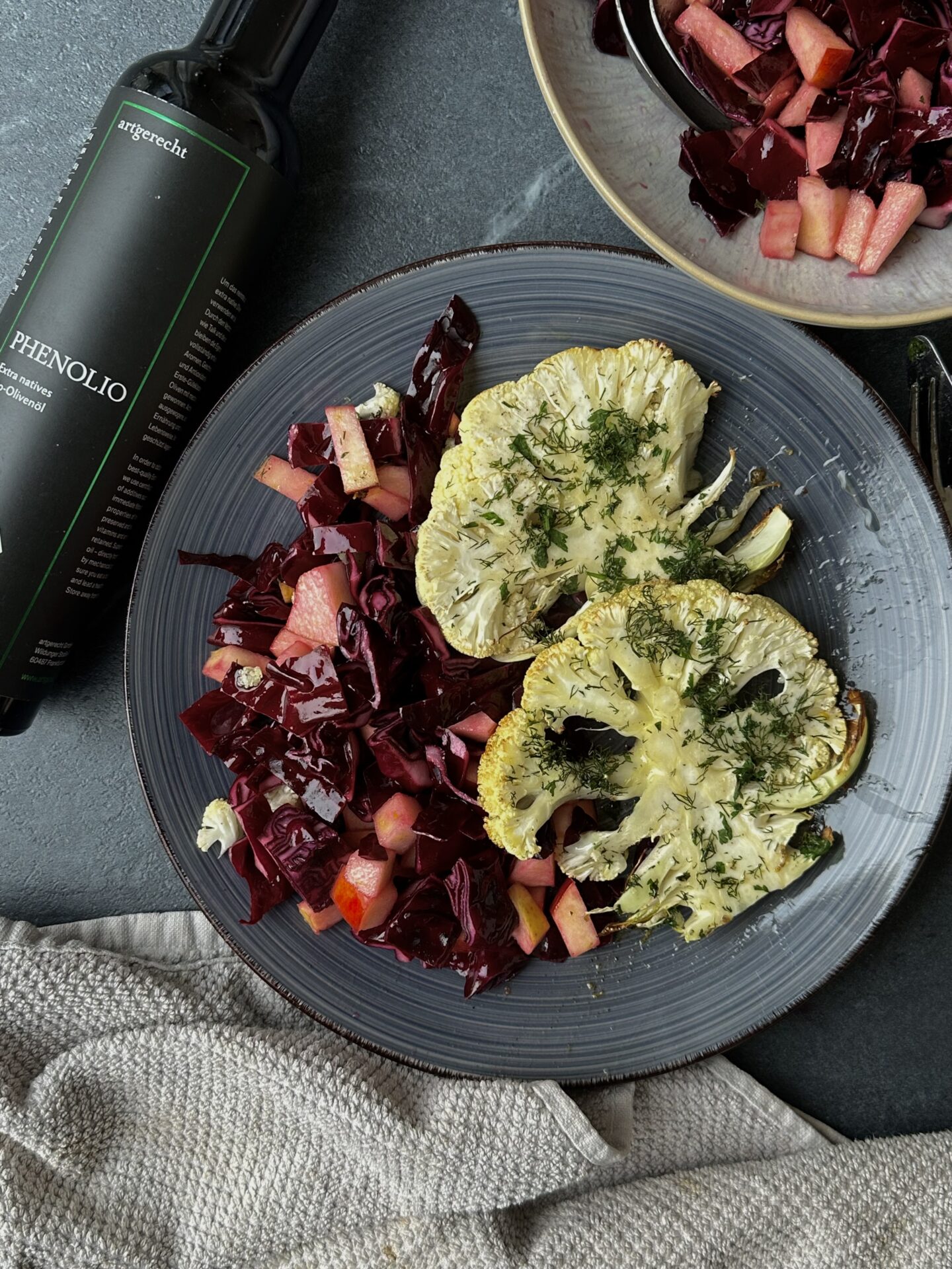 Vegetarian baked cauliflower steaks in a herb crust with red cabbage salad